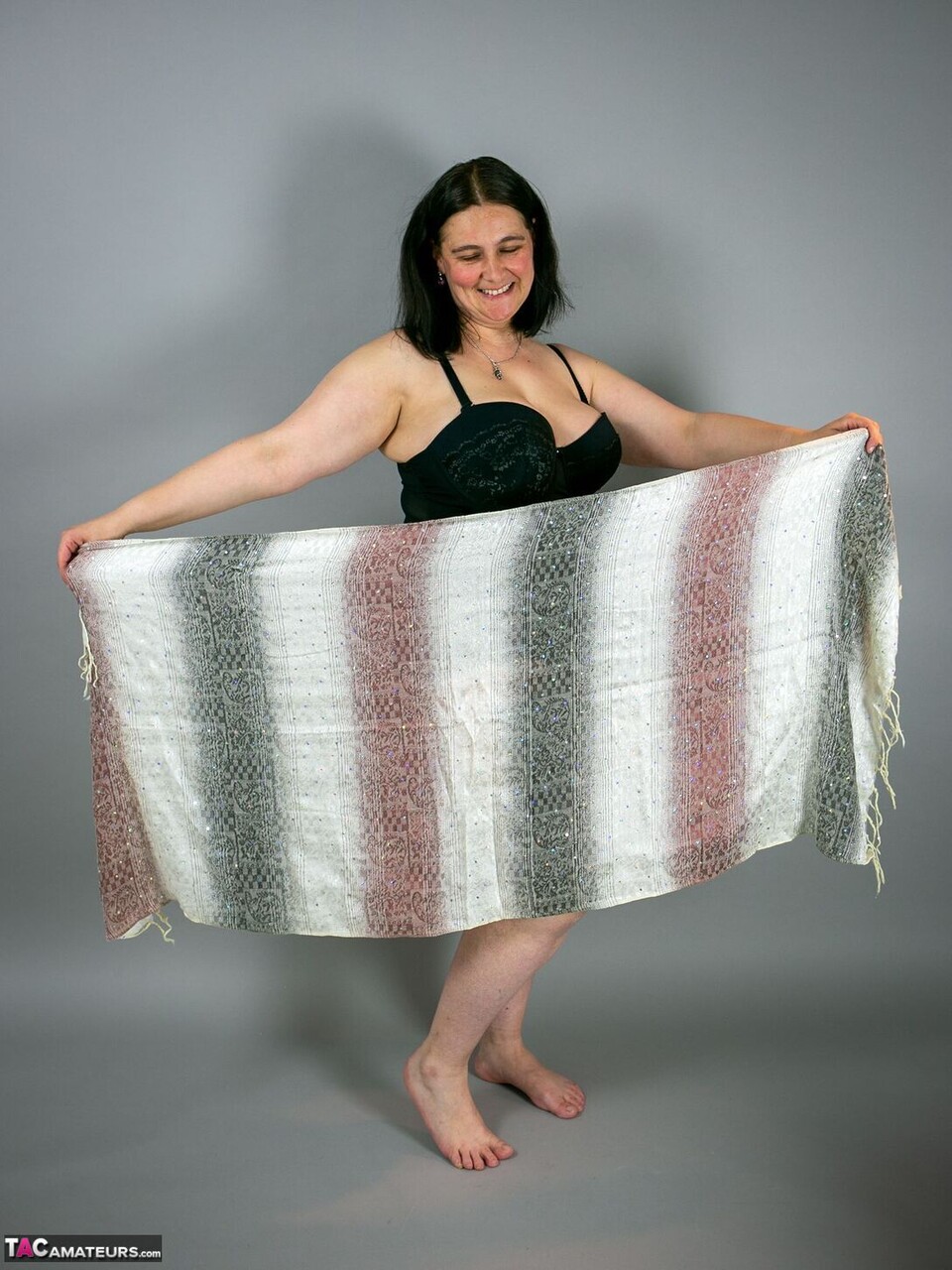 Brunette Amateur Posing Naked For Her Photographer Pulling Sheer Fabric