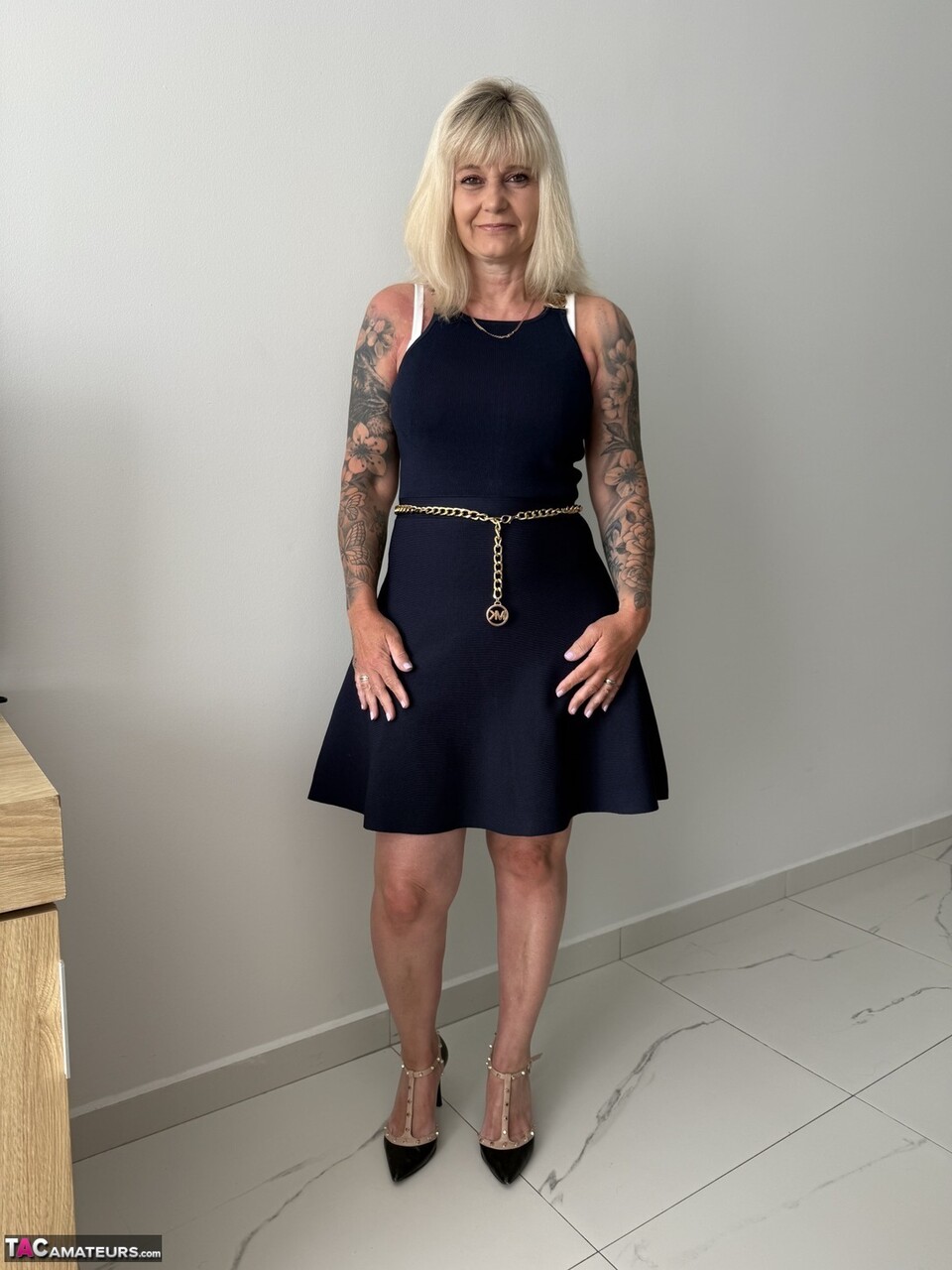 Tattooed Blonde Milf Unzips Dress To Get Naked In High Heels